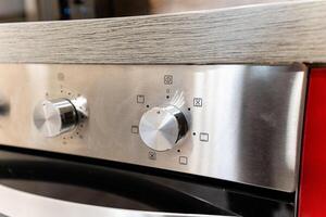 This image features a detailed closeup view of a stainless steel oven control panel, showcasing its sleek design and modern functionality, perfect for any contemporary kitchen photo