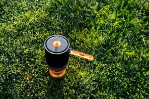 In this incredibly serene setting, vibrant and lush greenery envelops a charming pot placed on a stove, significantly enhancing the captivating beauty of the overall landscape photo