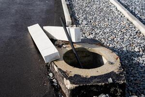 A sturdy and solid concrete block featuring a circular hole situated right in the center, which can serve various practical applications and uses in multiple fields and industries photo