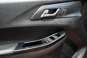 This image features a detailed close up of a car door prominently displaying the intricate design of a door handle, which is an essential component of the vehicles accessibility and style photo
