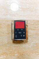 Introducing a sophisticated and contemporary digital control panel specifically designed for bathing systems found in luxurious and upscale bathrooms photo