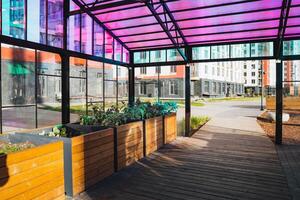 The contemporary urban garden structure features a vibrant and colorful canopy, adding beauty and a touch of nature to the cityscape photo
