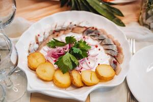 A colorful plate on the table displays a variety of mouthwatering foods like savory potatoes and tender meat, inviting all to enjoy a cozy meal filled with good cheer and conversation photo