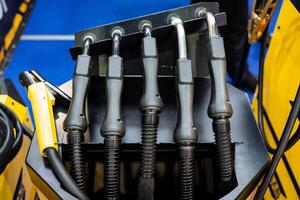 This image features a detailed closeup view of a complex machine that has numerous wires coming out of it, showcasing the intricate design and engineering behind its operation photo