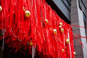 The vibrant red ribbons adorned with shiny gold bells work together to create an enchanting festive atmosphere, adding a charming decorative touch to any setting or occasion photo
