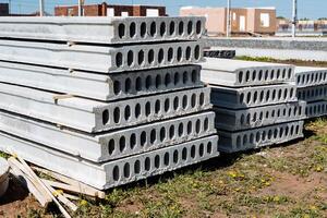 A stack of concrete slabs arranged atop each other at a construction site, enhanced by urban design elements and landscaping features, showcasing a fusion of modernity and functionality photo