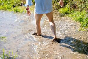 Enjoying a tranquil walk through the serene experience of shallow, muddy water in the heart of nature is a beautiful escape that brings joy photo