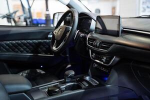 The interior of a modern car features a sleek tablet prominently displayed on the dashboard, enhancing the digital experience and connectivity for the driver and passengers photo