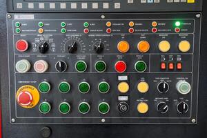 A control panel prominently features a bright red button labeled Emergency Stop, ensuring immediate action can be taken in case of a machinery malfunction or urgent safety situation photo