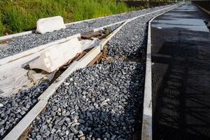 A gravelcovered train track offers a strong surface for smooth travel, while maintaining structural integrity and ensuring no obstructions or instability along the route photo