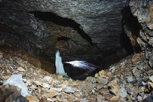 Deep within the caves mysterious depths, there exists a breathtaking and mesmerizing ice formation at its very center, showcasing an incredible and stunning display of natural beauty photo