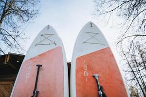Two exquisitely decorated surfboards, both adorned with the letter k, eagerly await a thrilling day filled with adventure and enjoyment as they are ready to take on the waves ahead photo