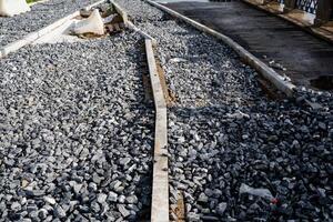 A strong and durable concrete curb placed atop a robust gravel pile creates a precise and defined boundary, which is crucial for successful roadside and landscape design projects photo