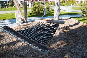 A colorful hammock sways gently in the warm sand at a beautiful park, creating an ideal spot for relaxation and enjoying the soothing tranquility and peacefulness of nature all around them photo