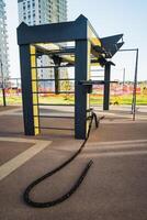 A rope is tied to a metal structure in a park photo