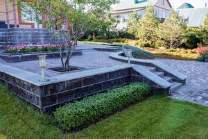 In the center of the beautiful garden, there stands a magnificent tree that adds charm and character to the surrounding area, providing shade and a home for various wildlife photo