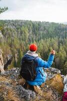 Discover the Great Outdoors A Passionate Hiker Enjoying Natures Touch at a Scenic Lookout, Overwhelmed by Its Majestic Beauty and Splendor photo