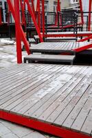 A beautifully designed wooden deck with vibrant red railings and elegant stairs enhances the outdoor area, ideal for relaxation and creating cherished memories with family and friends photo