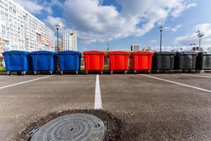 The aligned trash cans in the parking lot contribute to a clean, organized visual appearance, significantly enhancing the overall condition of the surrounding environment photo