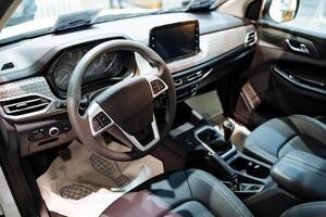 The interior of a modern automobile features a steering wheel along with comfortable seats, providing essential components for the functionality and familiarity of the driving experience photo