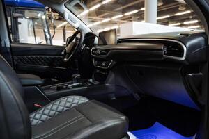 The elegant interior of a car, complete with an aesthetically pleasing design, is prominently displayed in a modern showroom that attracts potential buyers and automotive enthusiasts alike photo