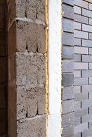 A closeup look at a brick wall with foam insulation. Keywords Wood, Building, Brickwork, Brick, Building material, Rectangle, Composite material, Automotive tire, Pattern, Metal photo
