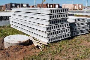 A stack of concrete blocks at a construction site demonstrates preparation for building foundation, a significant step in construction and infrastructure development photo