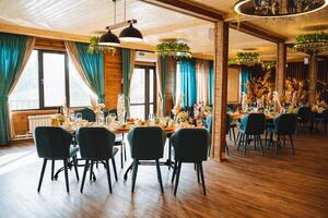 A beautifully decorated restaurant featuring tables and chairs that have been thoughtfully arranged for a delightful wedding reception celebration, creating a perfect ambience for the event photo