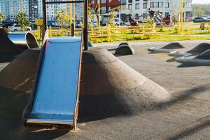 At a playground, there is a colorful slide sitting majestically on top of a hill, ready to provide hours of fun for children who come to play and enjoy outdoor activities photo