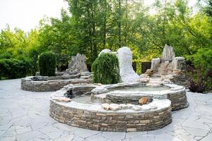 The Central Park area features a beautiful fountain surrounded by lush greenery, creating a tranquil oasis in the midst of the bustling city. It perfectly blends nature with urban life photo