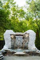 Visitors to the park are captivated by the breathtaking waterfall that resembles angel wings, blending art and nature into a mesmerizing sight that leaves a lasting impression photo