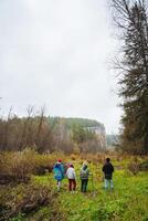 A group of friends sets out to explore the wilderness together on a cloudy day, embarking on an adventure filled with companionship photo