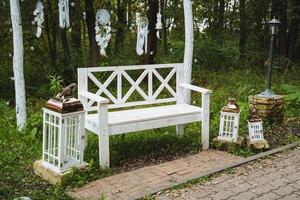 In the midst of a serene forest, a striking white bench stands as a perfect spot for visitors to pause, reflect, and fully enjoy the breathtaking beauty of the surrounding nature photo