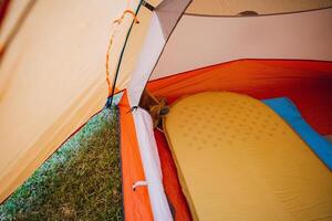 To enhance your camping experience, create a cozy atmosphere in your tent with an air mattress. It provides comfort and safety for a relaxing wilderness adventure photo