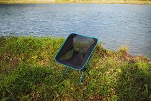 Experience the ultimate in comfort and relaxation with a Riverside Portable Camping Chair, which is ideal for enjoying the outdoors amidst nature photo