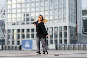 Young woman performs dance in urban setting with modern architecture photo