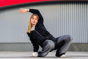 Dancer showcases movement style during urban performance in the city photo