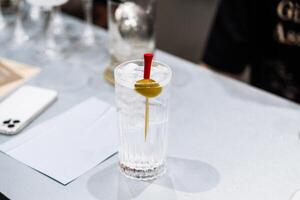 Tasting cocktails and preparing drinks at a bustling bar in the evening photo