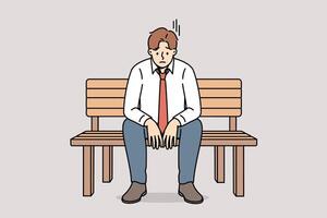 Depressed business man sitting on park bench and feeling sad about financial problems vector