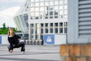 Dance performance on urban pavement with modern architecture in background photo