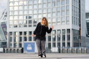 Dancer performs contemporary routine in urban setting during late afternoon photo