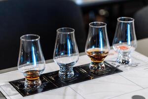 Tasting session with whiskey samples and cocktail preparations at a bar photo