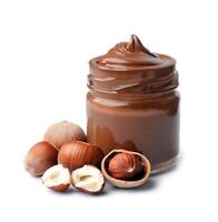 Chocolate spread with filbert nuts on white backgrounds photo