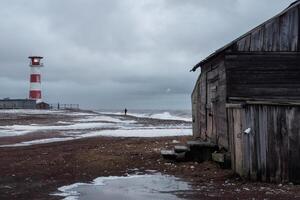Dramatic seascape with a raging sea and a fishing hut on the sho photo