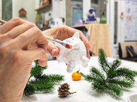 Selective focus. Creating a handmade toy. Cheerful wadding toy cats by handmade. photo