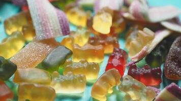 Colorful Gummy Bears and Candy Assortment on a Blue Background video
