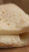 A delectable presentation of creamy goat cheese arranged on a rustic wooden cutting board video