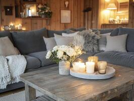 cozy living room with soft blankets, candles, and wooden table photo