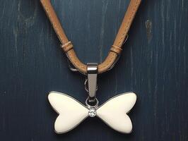 Elegant butterfly pendant with diamond accent on leather necklace photo
