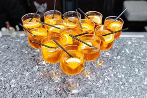 Refreshing aperol spritz cocktails standing on a bar counter photo